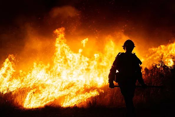 A firefighter works as the Hughes Fire burns on January 22, 2025, in Castic, Calif.