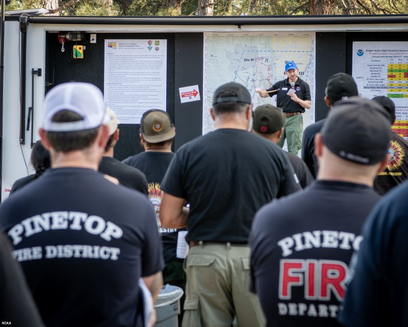 Fire crews receive weather briefings.