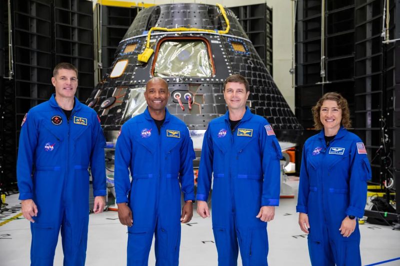 Artemis 2 crewin front of their Orion spacecraft